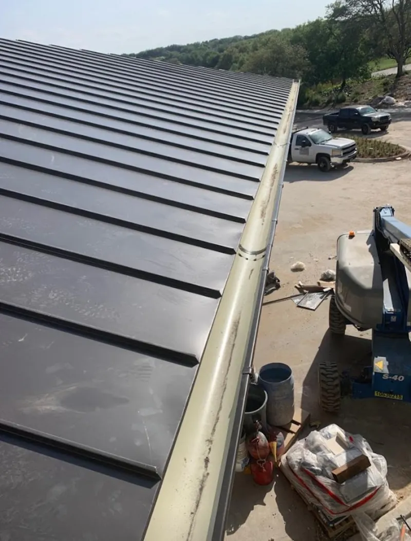 Standing seam panel and gutter detail on a metal roofing jobsite in Old Tappan
